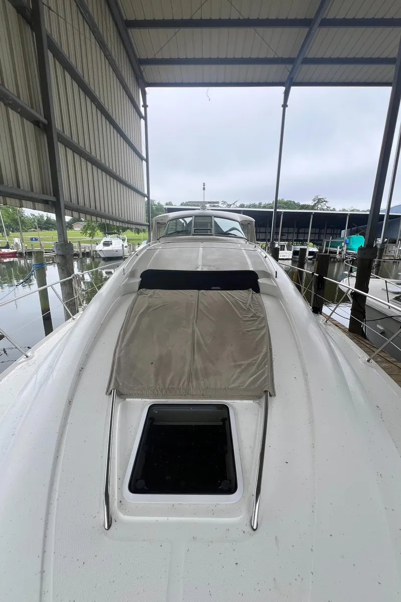 Slide: The Image of 2004 Sea Ray 480 Motor Yacht docked under a covered marina. - 24