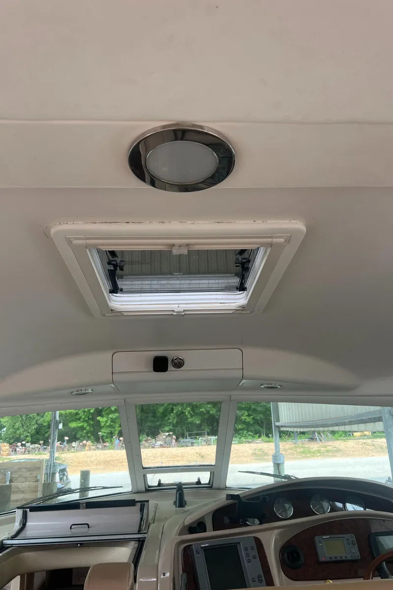 Slide: The Image of 2004 Sea Ray 480 Motor Yacht interior with open sunroof and control panel. - 27