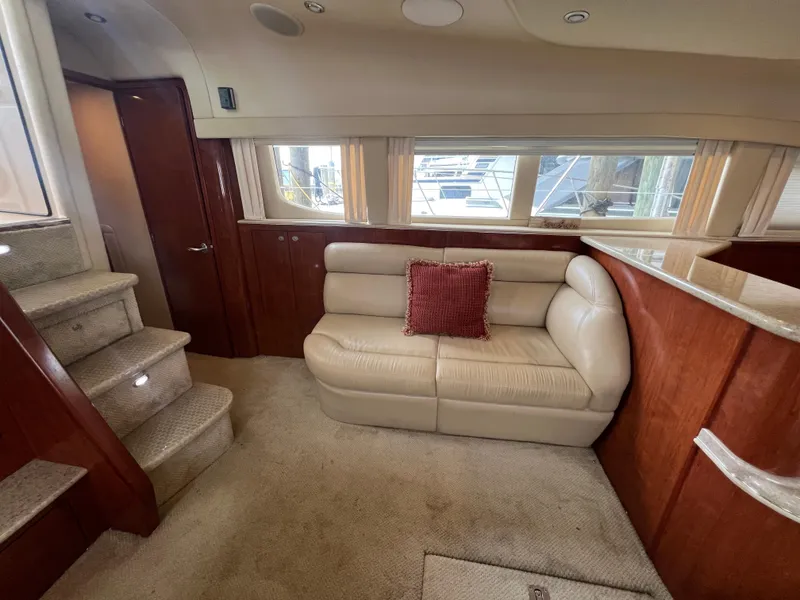 Slide: The Image of Luxurious interior of 2004 Sea Ray 480 Motor Yacht with plush seating and elegant wood finishes. - 32