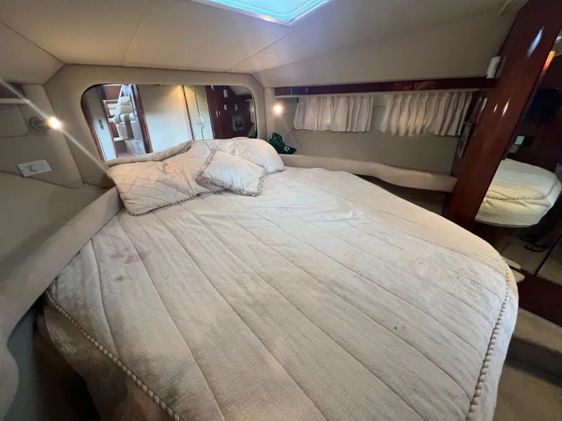 Slide: The Image of Luxurious bedroom interior of 2004 Sea Ray 480 Motor Yacht with cozy bedding. - 40
