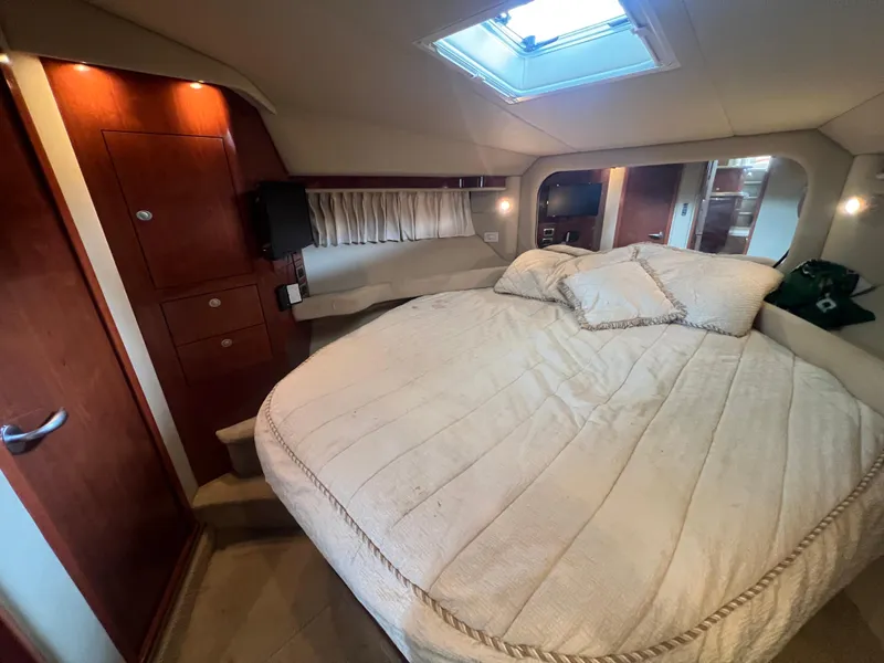 Slide: The Image of Luxurious bedroom interior of 2004 Sea Ray 480 Motor Yacht with cozy bedding and wood accents. - 41