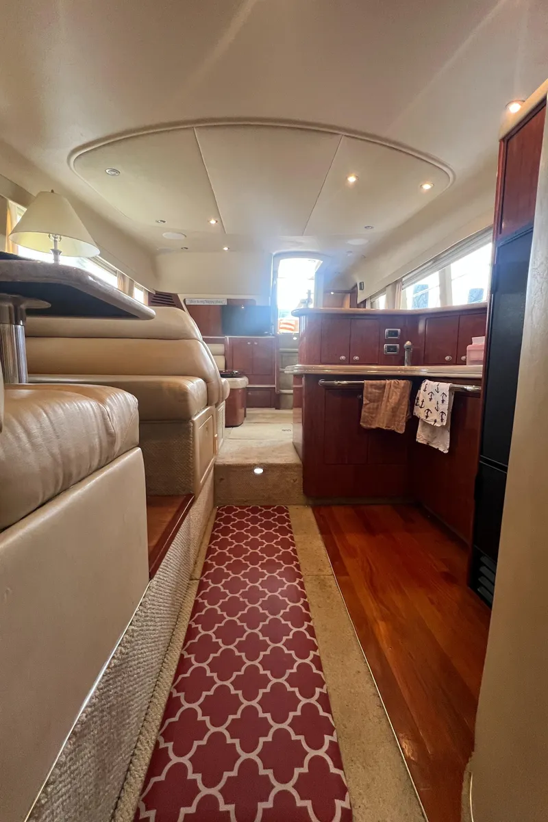 Slide: The Image of Interior of 2004 Sea Ray 480 Motor Yacht with luxurious seating and wooden flooring. - 43