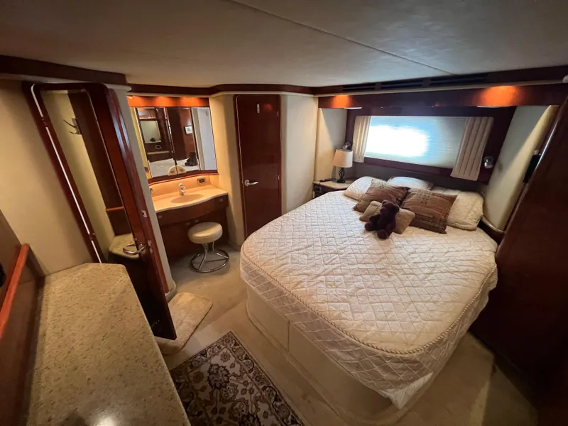 Slide: The Image of Luxurious 2004 Sea Ray 480 Motor Yacht bedroom with cozy bed and elegant decor. - 47