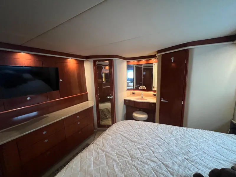 Slide: The Image of Luxurious cabin interior of 2004 Sea Ray 480 Motor Yacht with wood finishes and modern amenities. - 49