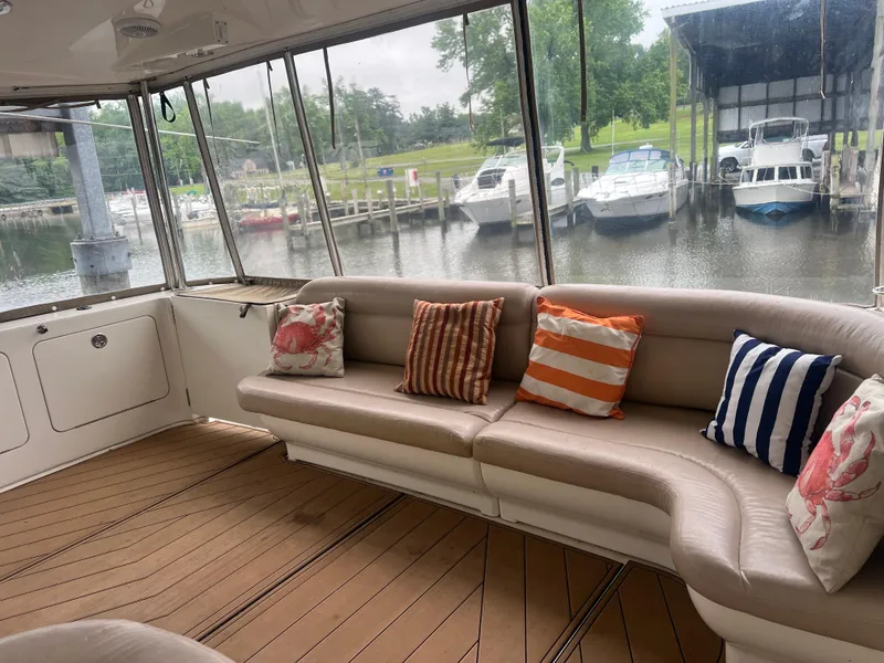 Slide: The Image of Luxurious 2004 Sea Ray 480 Motor Yacht interior with colorful cushions and marina view. - 6