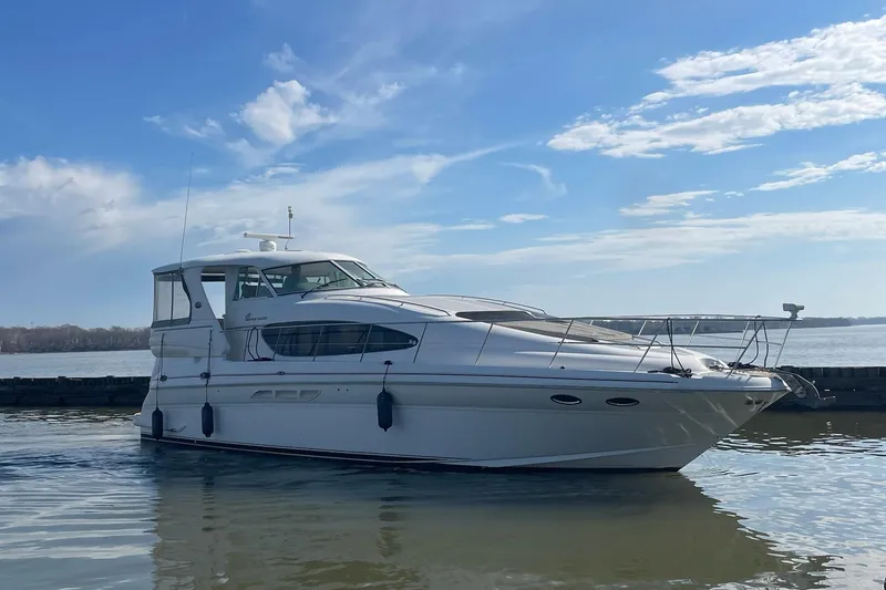 Slide: The Image of 2004 Sea Ray 480 Motor Yacht on calm water under a clear blue sky. - 68