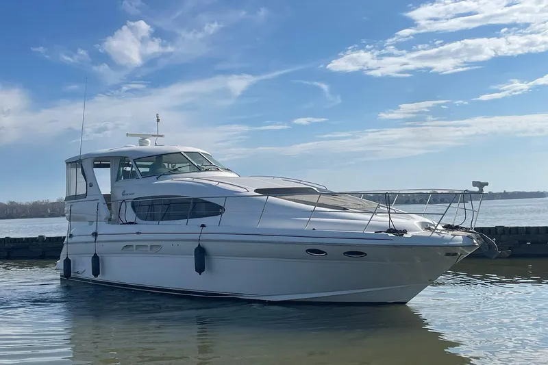 Slide: The Image of 2004 Sea Ray 480 Motor Yacht on calm water under a blue sky. - 69