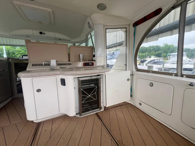 Slide: The Image of Interior of 2004 Sea Ray 480 Motor Yacht with kitchenette and wooden flooring. - 9