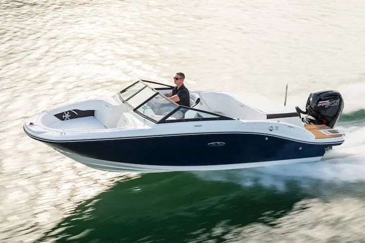 The Image of 2020 Sea Ray SPX 190 Outboard boat docked, featuring a blue canopy and Mercury engine. - 0