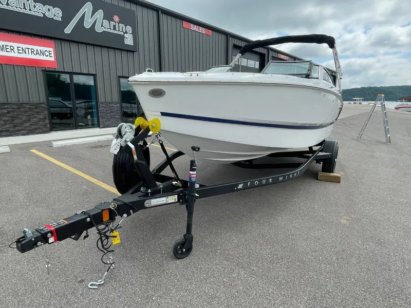 Slide: The Image of 2025 Four Winns H1 boat on trailer at marine dealership. - 3