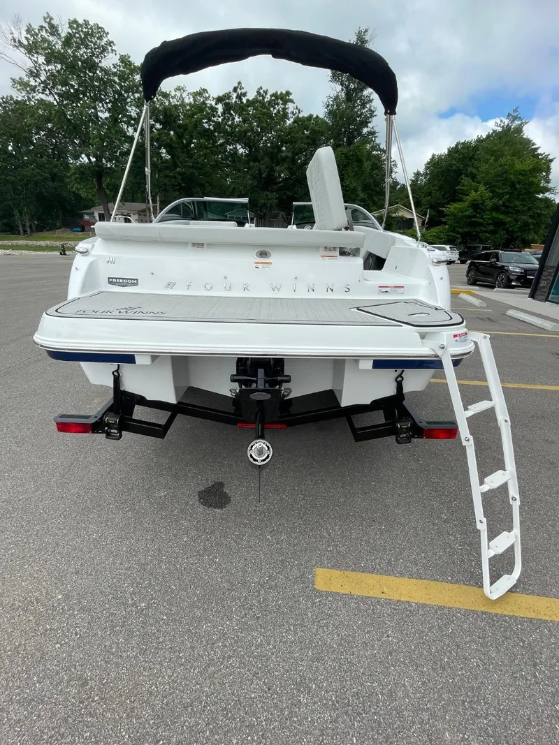 Slide: The Image of 2025 Four Winns H1 boat rear view with swim platform and ladder. - 4