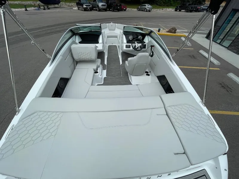 Slide: The Image of 2025 Four Winns H1 boat interior with sleek white seating and modern dashboard. - 5