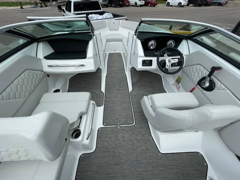 Slide: The Image of 2025 Four Winns H1 boat interior with modern white seating and sleek dashboard design. - 6