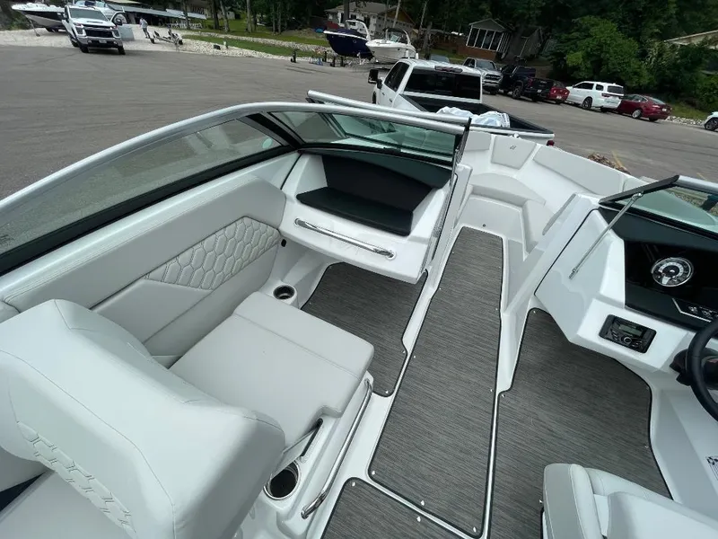 Slide: The Image of 2025 Four Winns H1 boat interior with sleek seating and modern dashboard design. - 8