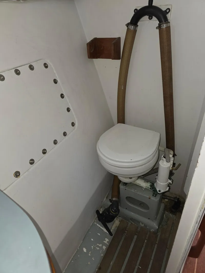 Slide: The Image of Compact marine toilet in 1986 Santa Cruz 50 sailboat bathroom. - 16