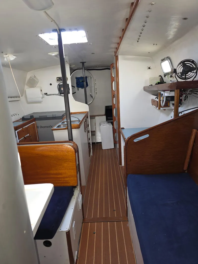 Slide: The Image of Interior of 1986 Santa Cruz 50 sailboat with wooden finishes and compact layout. - 23
