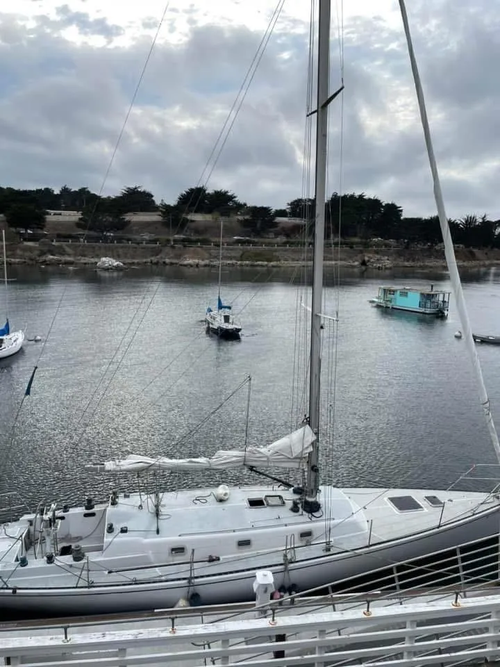 Slide: The Image of Sailboat docked in a calm harbor under cloudy skies, Santa Cruz 50, 1986 model. - 3