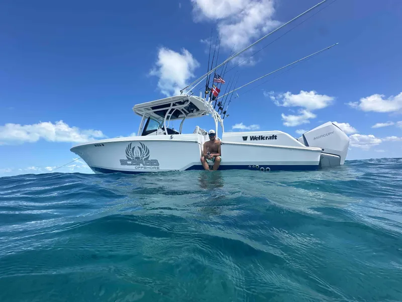 The Image of 2023 Wellcraft 302 Fisherman boat in shallow water under a blue sky. - 0