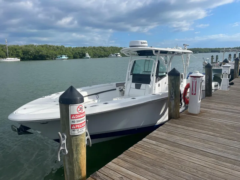 Slide: The Image of 2023 Wellcraft 302 Fisherman boat docked on a sunny day. - 10