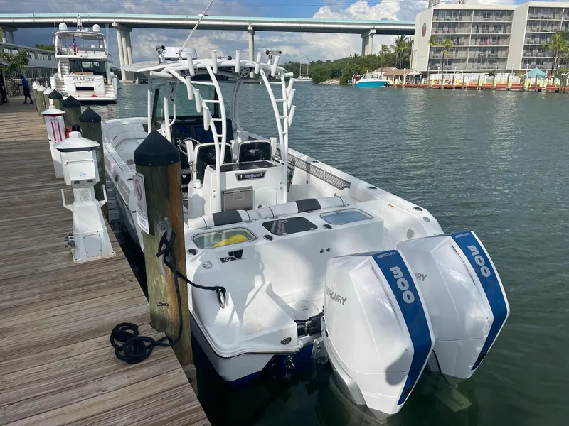 Slide: The Image of 2023 Wellcraft 302 Fisherman boat docked with twin Mercury 300 engines. - 16