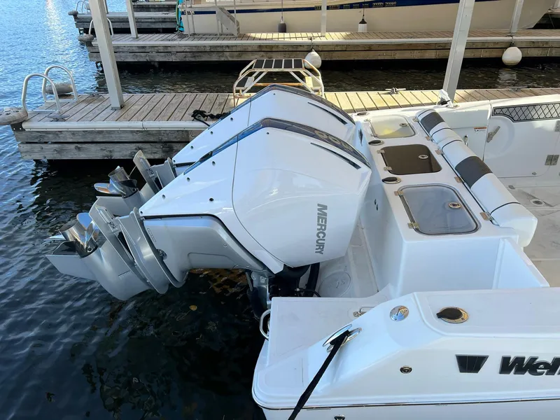Slide: The Image of 2023 Wellcraft 302 Fisherman boat with dual Mercury outboard engines docked at marina. - 17