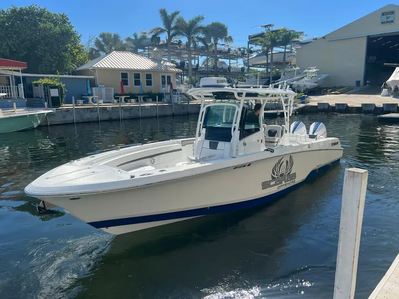 Slide: The Image of 2023 Wellcraft 302 Fisherman boat docked in a sunny marina setting. - 18