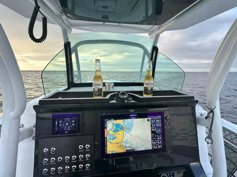 Slide: The Image of 2023 Wellcraft 302 Fisherman boat dashboard with steering wheel and navigation controls. - 24