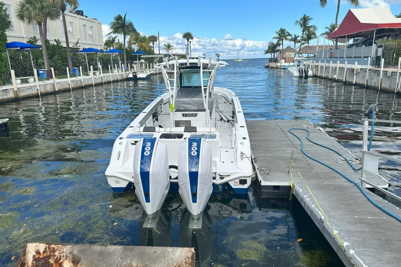 Slide: The Image of 2023 Wellcraft 302 Fisherman boat docked at a marina with twin engines. - 26