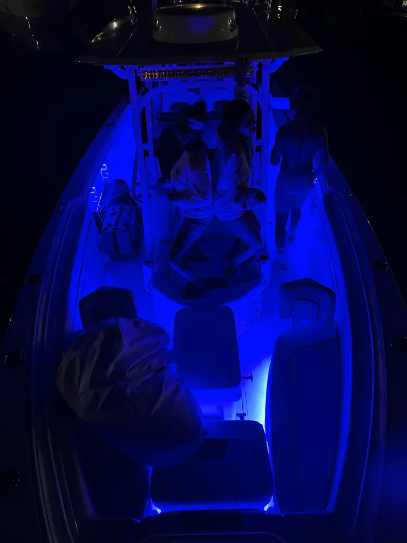 Slide: The Image of 2023 Wellcraft 302 Fisherman boat on open water under clear blue sky. - 3