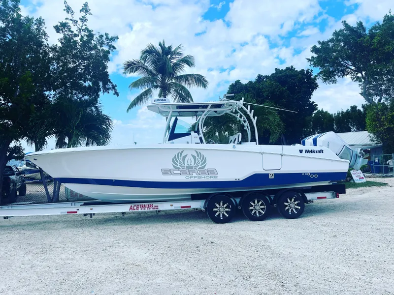 Slide: The Image of 2023 Wellcraft 302 Fisherman boat docked by waterfront buildings. - 4