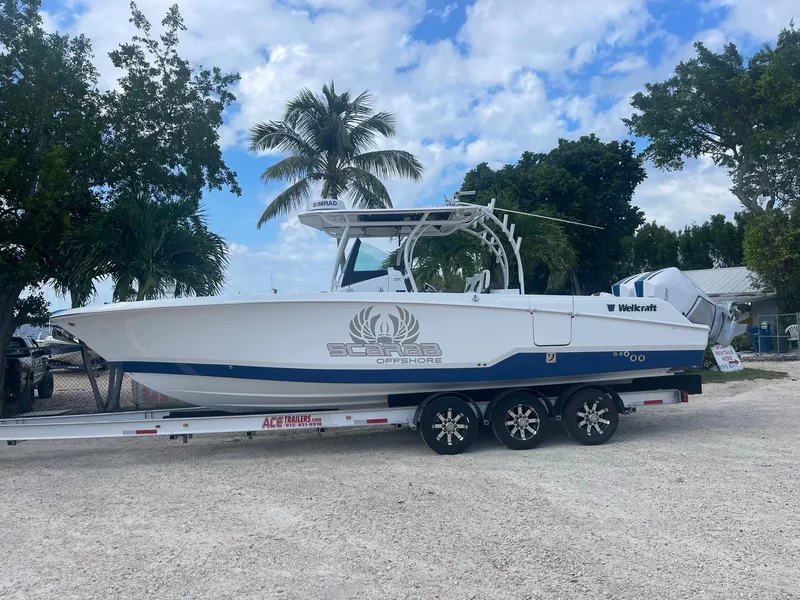Slide: The Image of 2023 Wellcraft 302 Fisherman boat docked near waterfront buildings. - 6