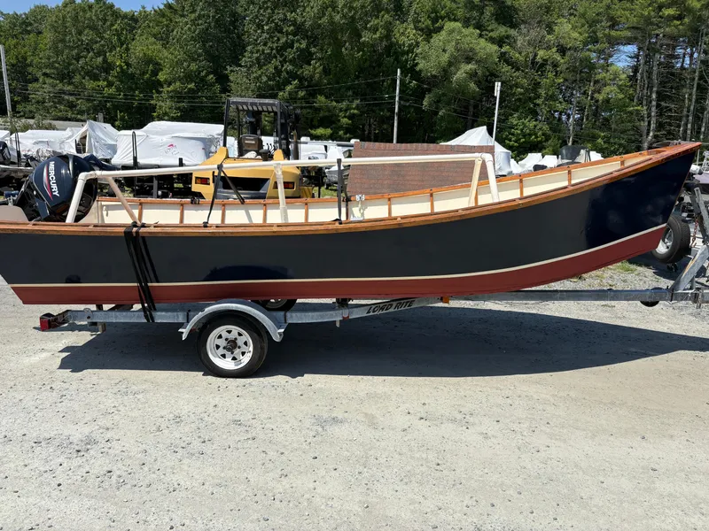 The Image of Custom Houghs Neck Skiff 176 boat on trailer, 2017 model, outdoors with trees in background. - 0