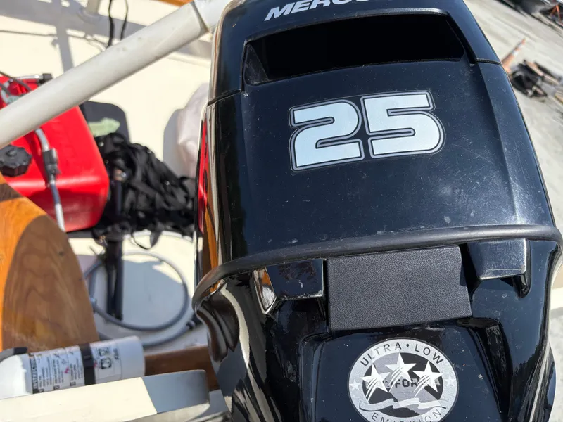 Slide: The Image of Outboard motor on 2017 Custom Houghs Neck Skiff 176, featuring "25" and ultra-low emission label. - 3