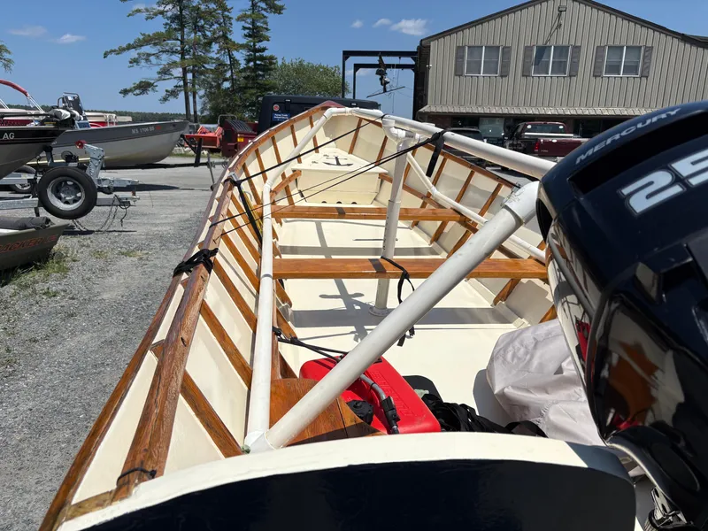 Slide: The Image of 2017 Custom Houghs Neck Skiff 176 with Mercury outboard motor, parked outdoors. - 4