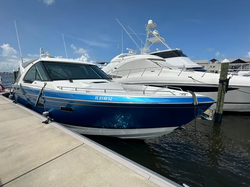 The Image of 2021 Formula 400 Super Sport Crossover yacht docked at marina under clear blue sky. - 0