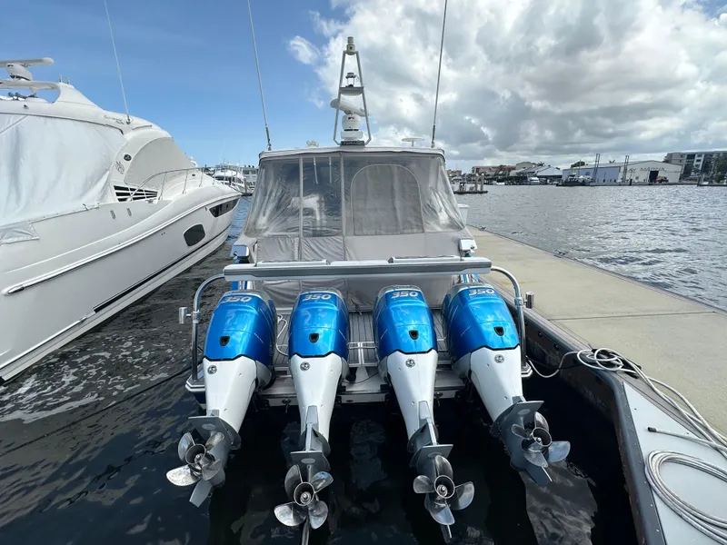 Slide: The Image of 2021 Formula 400 Super Sport Crossover with four powerful outboard engines docked at marina. - 2