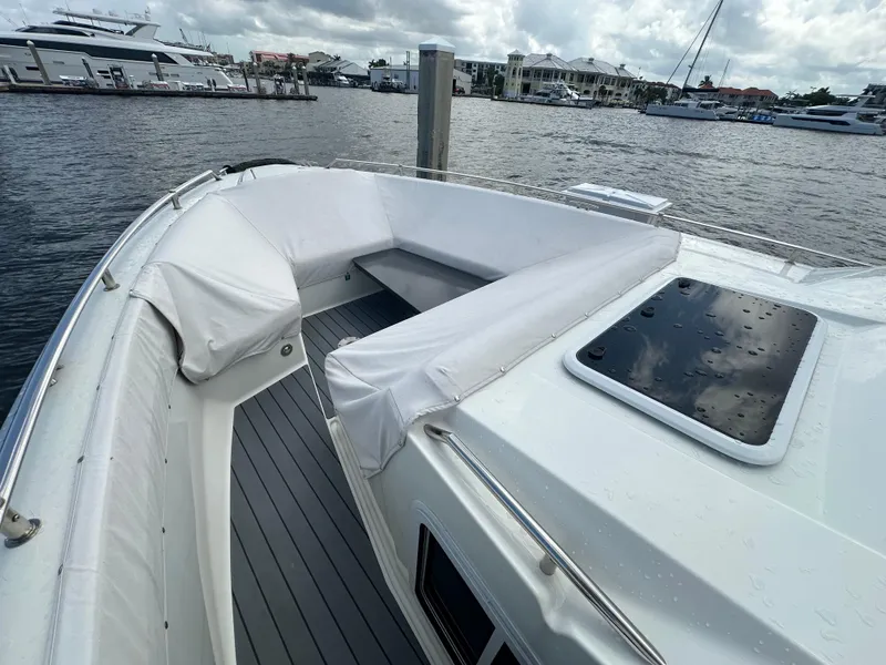 Slide: The Image of 2021 Formula 400 Super Sport Crossover yacht with spacious deck seating, docked at marina. - 4