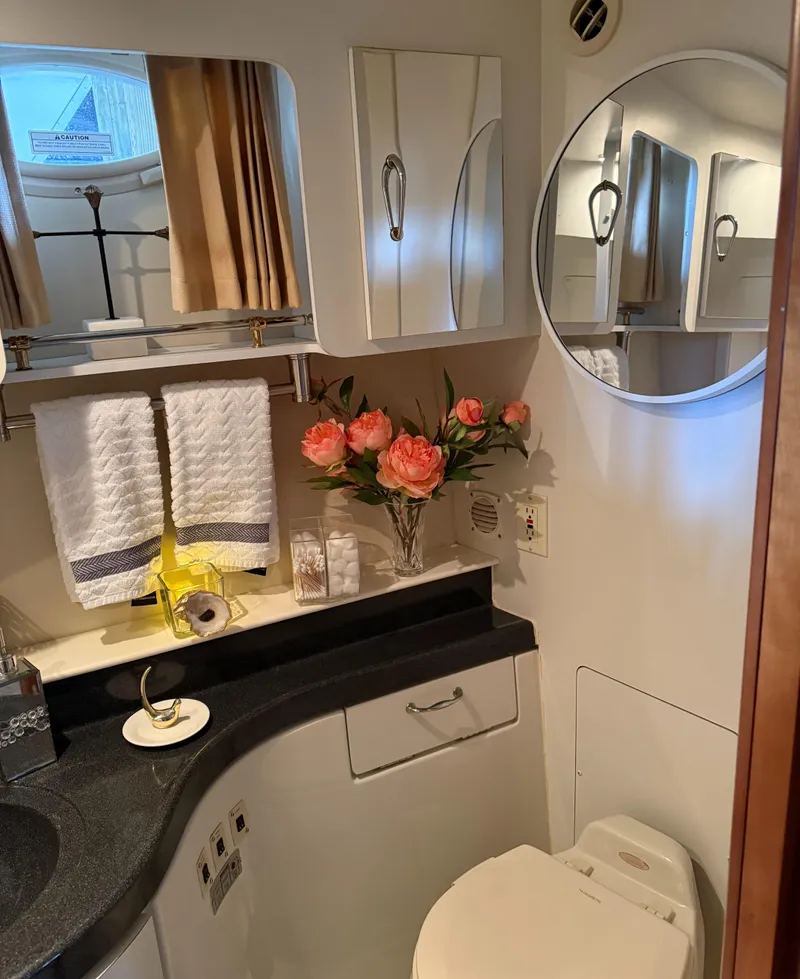 Slide: The Image of Bathroom interior of 2006 Carver 41 Cockpit Motor Yacht with flowers and towels. - 22