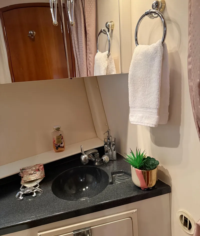 Slide: The Image of Bathroom interior of 2006 Carver 41 Cockpit Motor Yacht with sink and decor. - 27