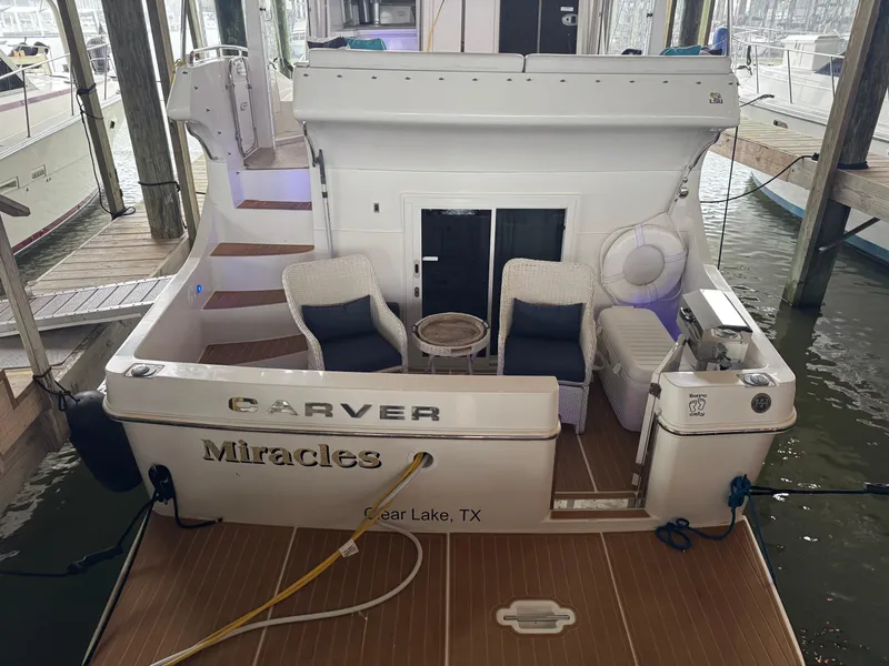 Slide: The Image of 2006 Carver 41 Cockpit Motor Yacht docked, featuring outdoor seating and Clear Lake, TX location. - 3