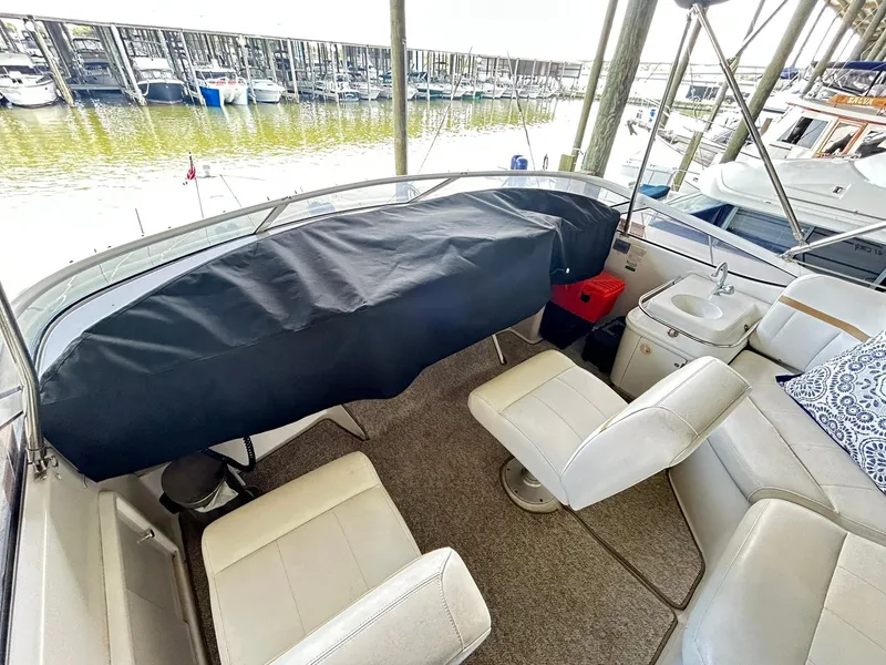 Slide: The Image of 2006 Carver 41 Cockpit Motor Yacht interior with seating, sink, and covered controls. - 30