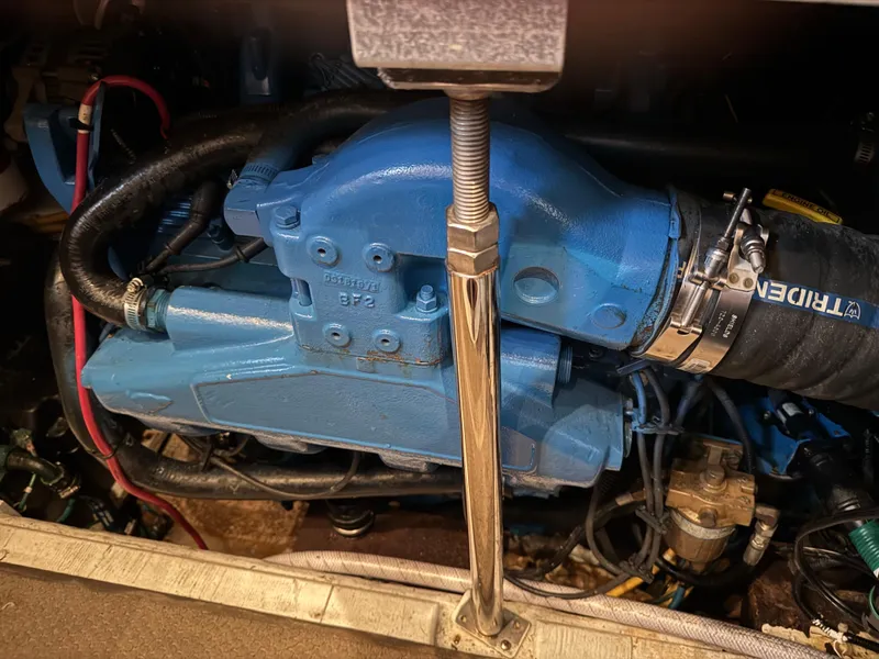 Slide: The Image of Engine compartment of a 2006 Carver 41 Cockpit Motor Yacht, featuring blue engine components. - 41