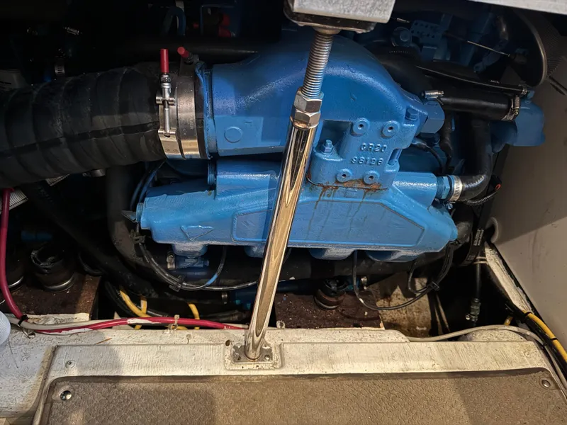 Slide: The Image of Engine compartment of a 2006 Carver 41 Cockpit Motor Yacht, featuring a blue engine. - 42