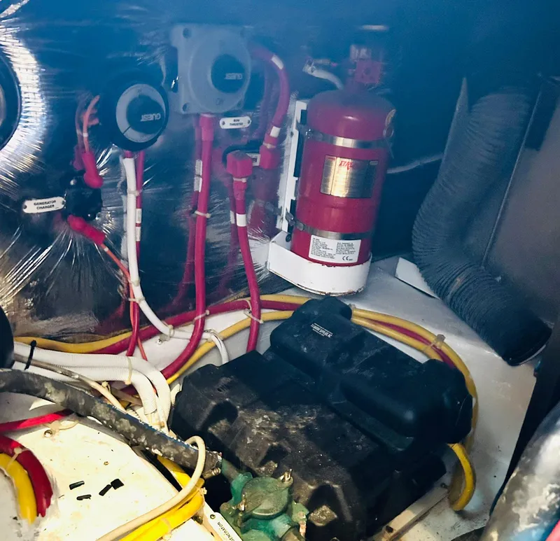 Slide: The Image of Engine room of 2006 Carver 41 Cockpit Motor Yacht with wiring and fire extinguisher. - 46