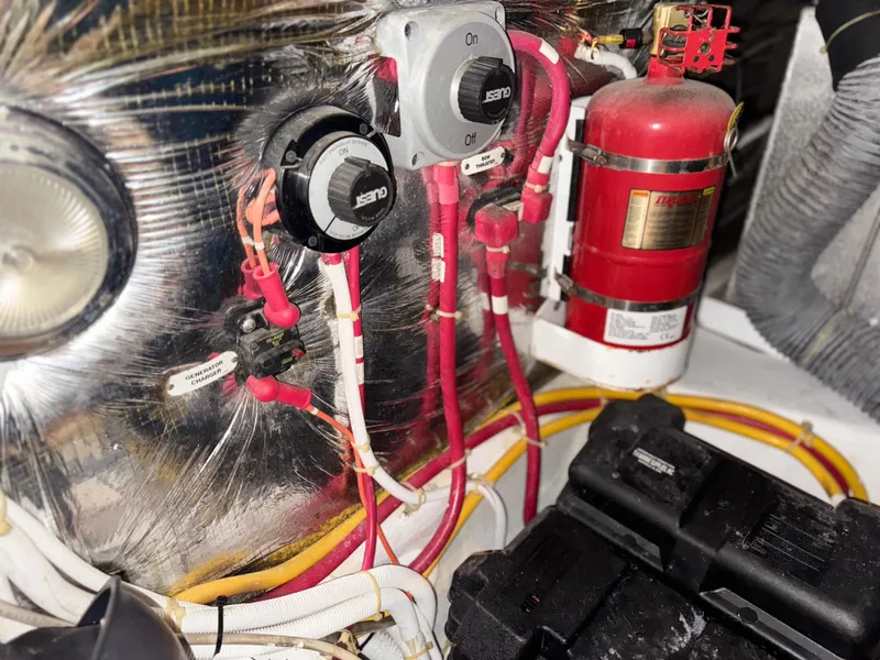 Slide: The Image of Engine room of 2006 Carver 41 Cockpit Motor Yacht with wiring and fire extinguisher. - 47