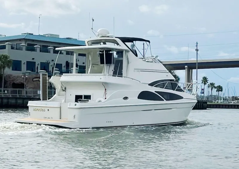 The Image of 2006 Carver 41 Cockpit Motor Yacht cruising near a marina. - 0