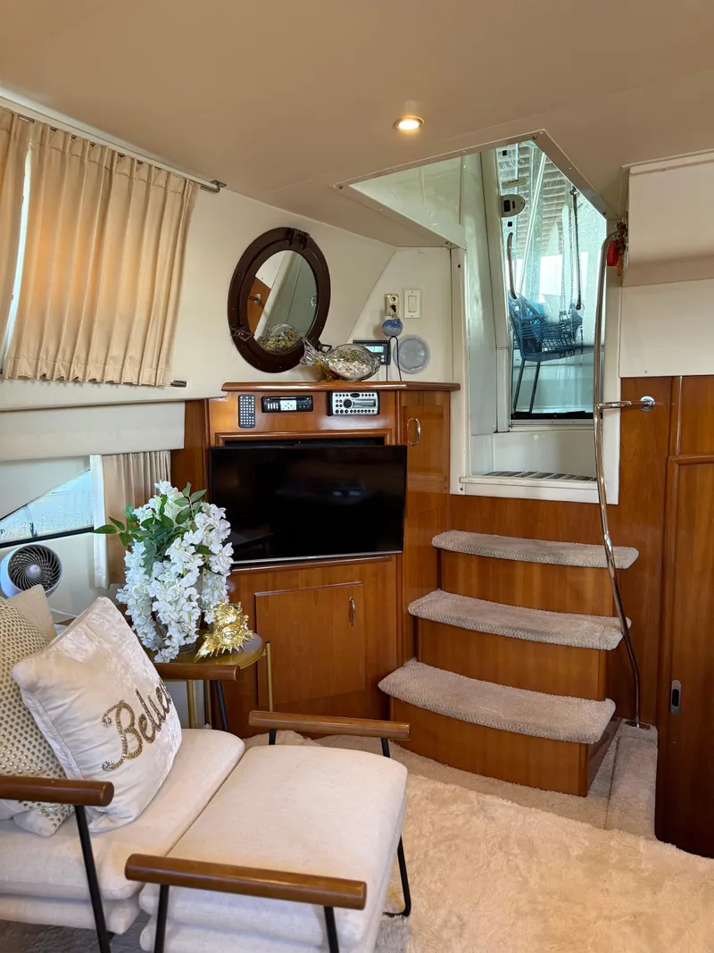Slide: The Image of Luxurious interior of 2006 Carver 41 Cockpit Motor Yacht with cozy seating and entertainment area. - 10
