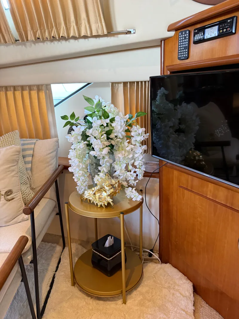 Slide: The Image of Interior of 2006 Carver 41 Cockpit Motor Yacht with floral decor and TV. - 12