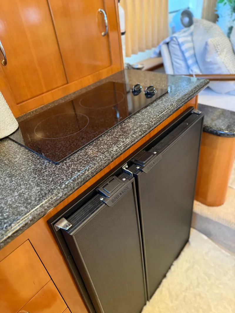 Slide: The Image of 2006 Carver 41 Cockpit Motor Yacht kitchen with stove and refrigerator. - 15