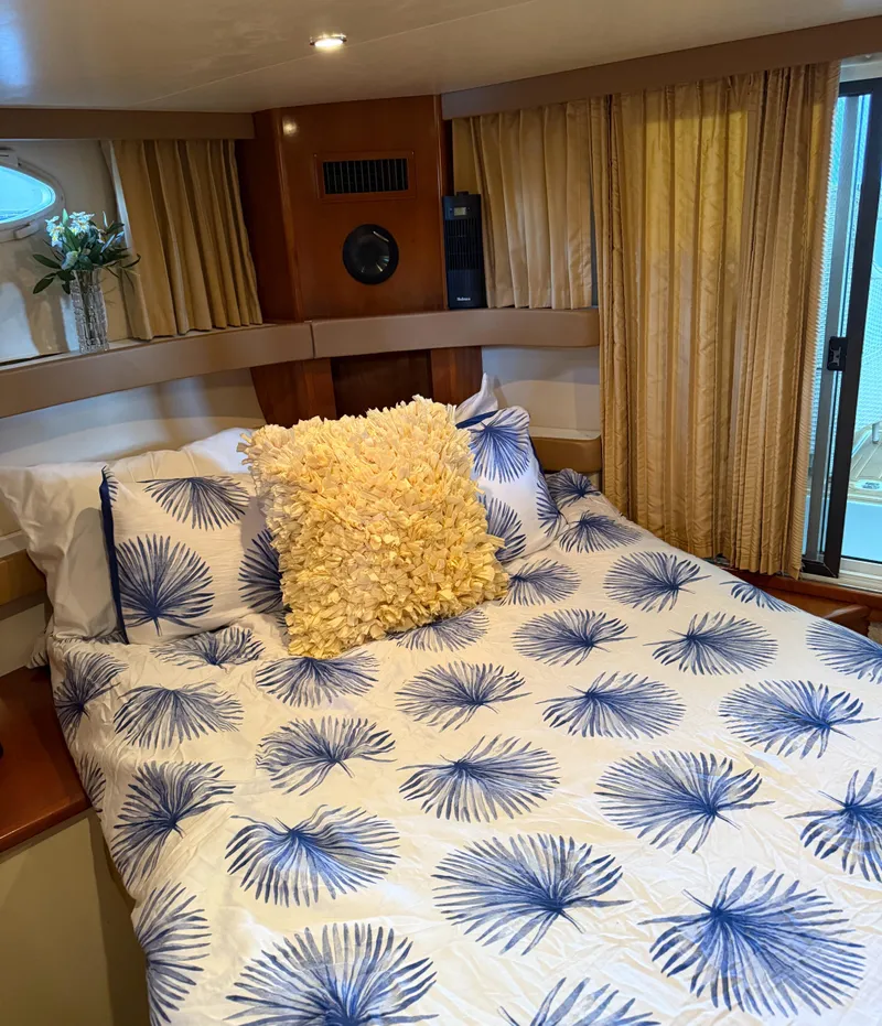 Slide: The Image of Cozy bedroom in 2006 Carver 41 Cockpit Motor Yacht with floral bedding and decorative pillows. - 18